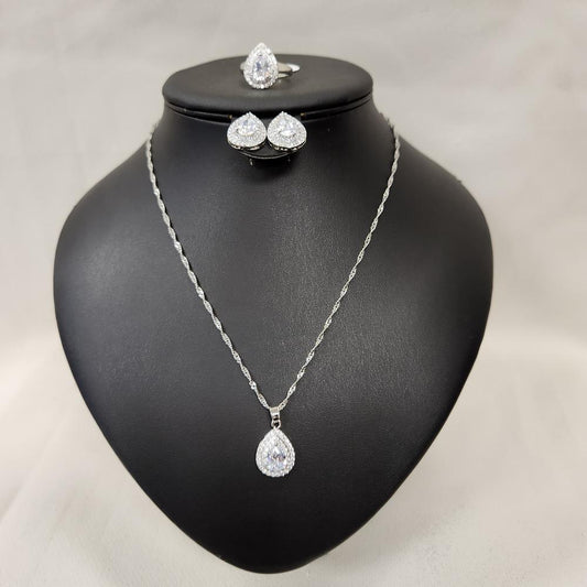 Front view of Four piece silver tone jewelry set with clear stones