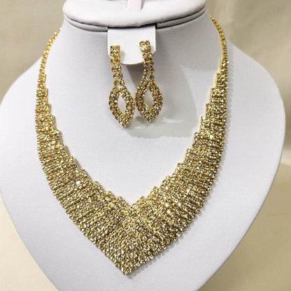 Gold three piece jewelry set adorned with round clear stones