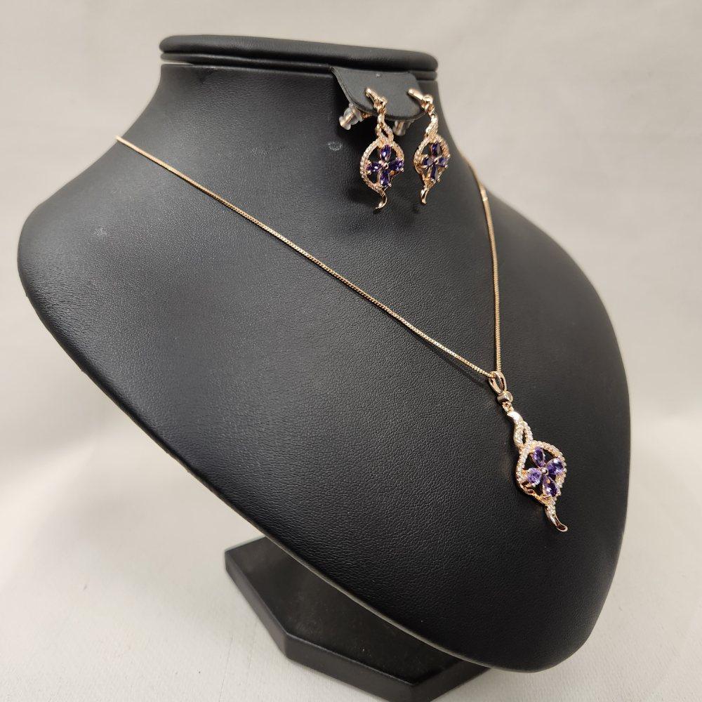 Side view of Three piece jewelry set with clear and purple stones