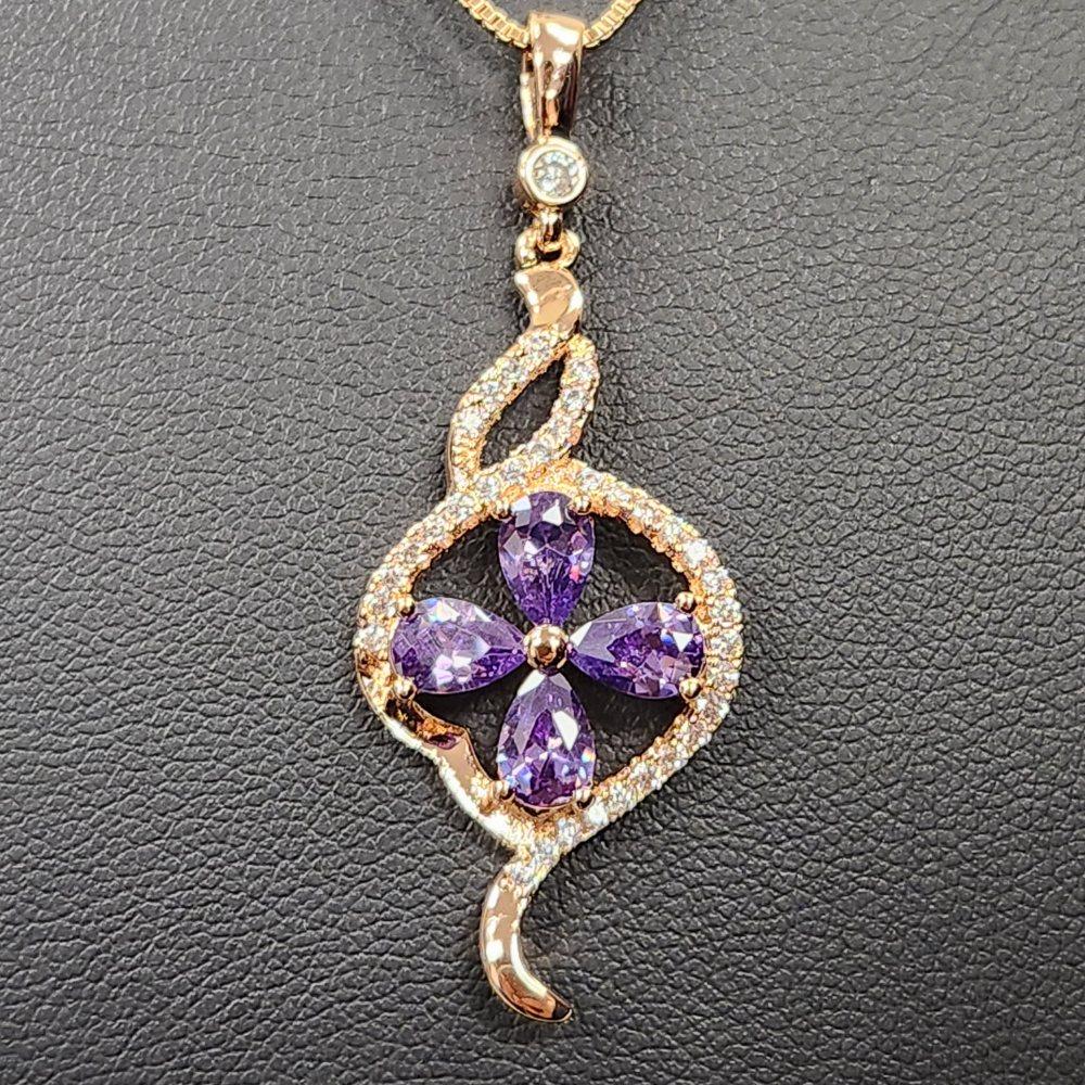 Detailed view of pendant with clear and purple stones