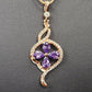 Detailed view of pendant with clear and purple stones
