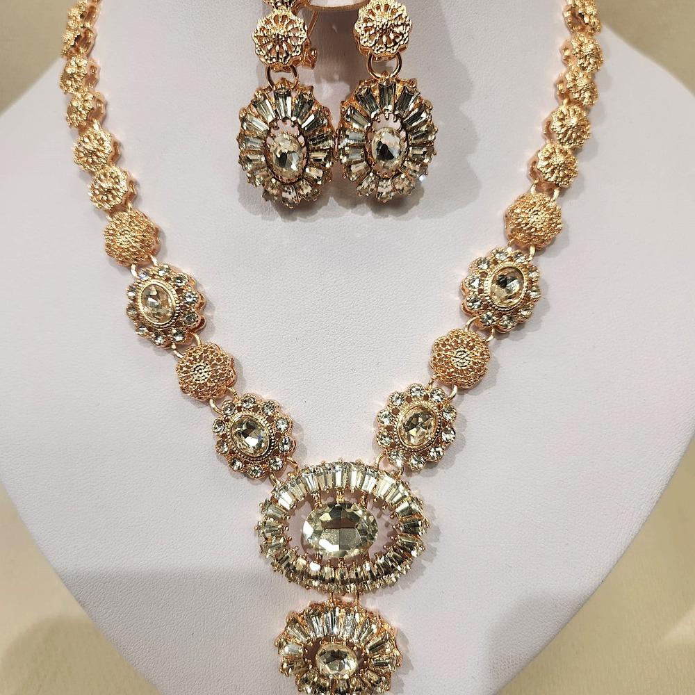 Detailed view of necklace and dangle earrings