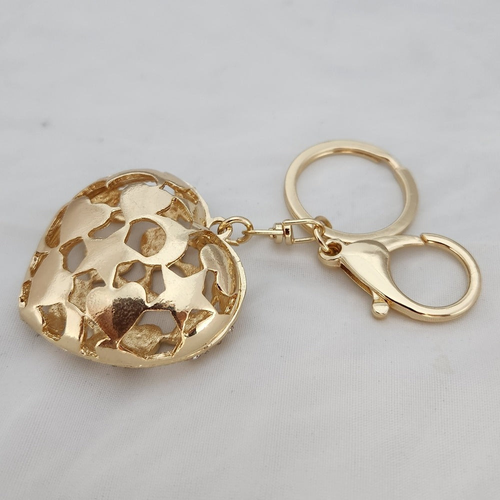 Heart shaped gold color purse charm when reversed