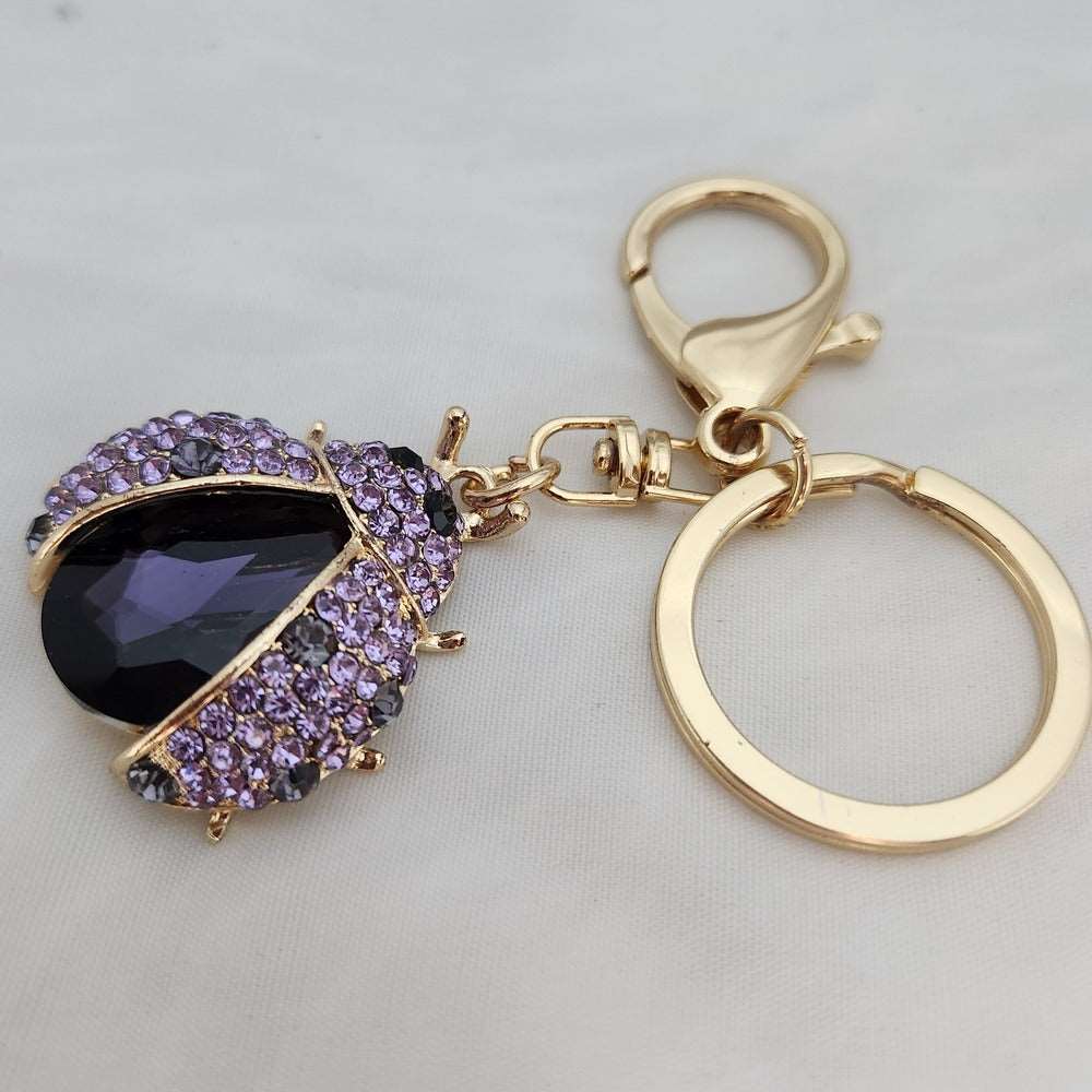 Key ring feature of Beatle shaped stone studded purse charm