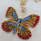 Stones on bright colorful butterfly shaped purse charm