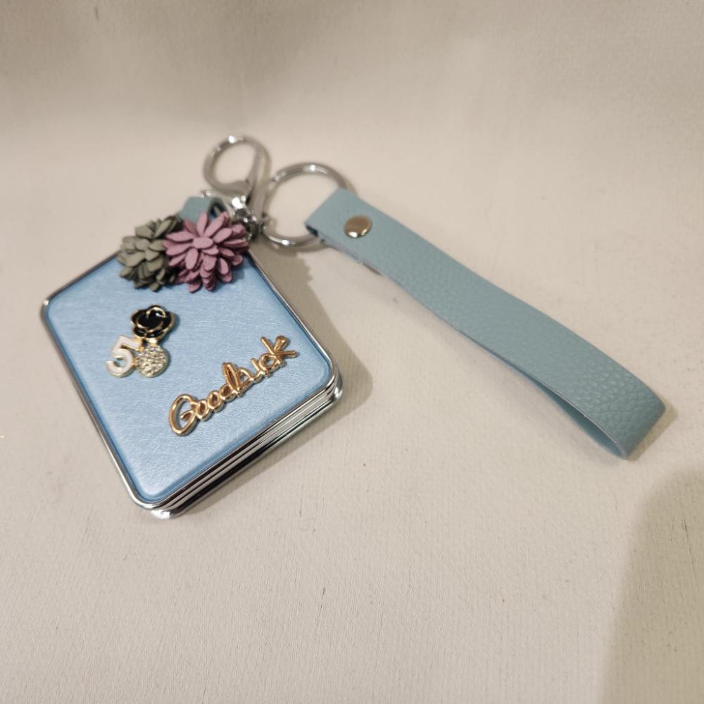 Full view of Mirror purse charm in pearly blue finish