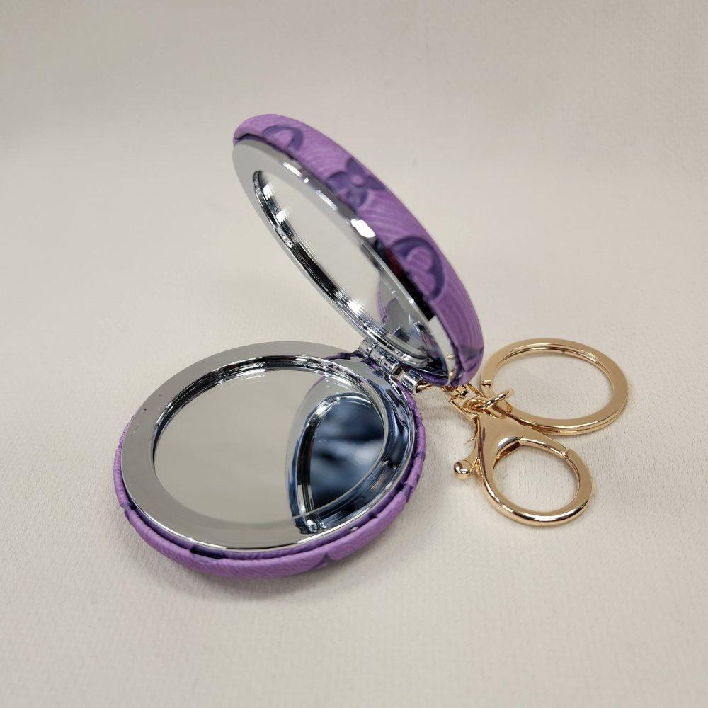 Lilac Pocket mirror with engraved floral pattern and a keyring when opened