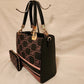 Side view of structured handbag with brown signature print