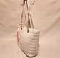 Side view of off white quilted artificial leather handbag