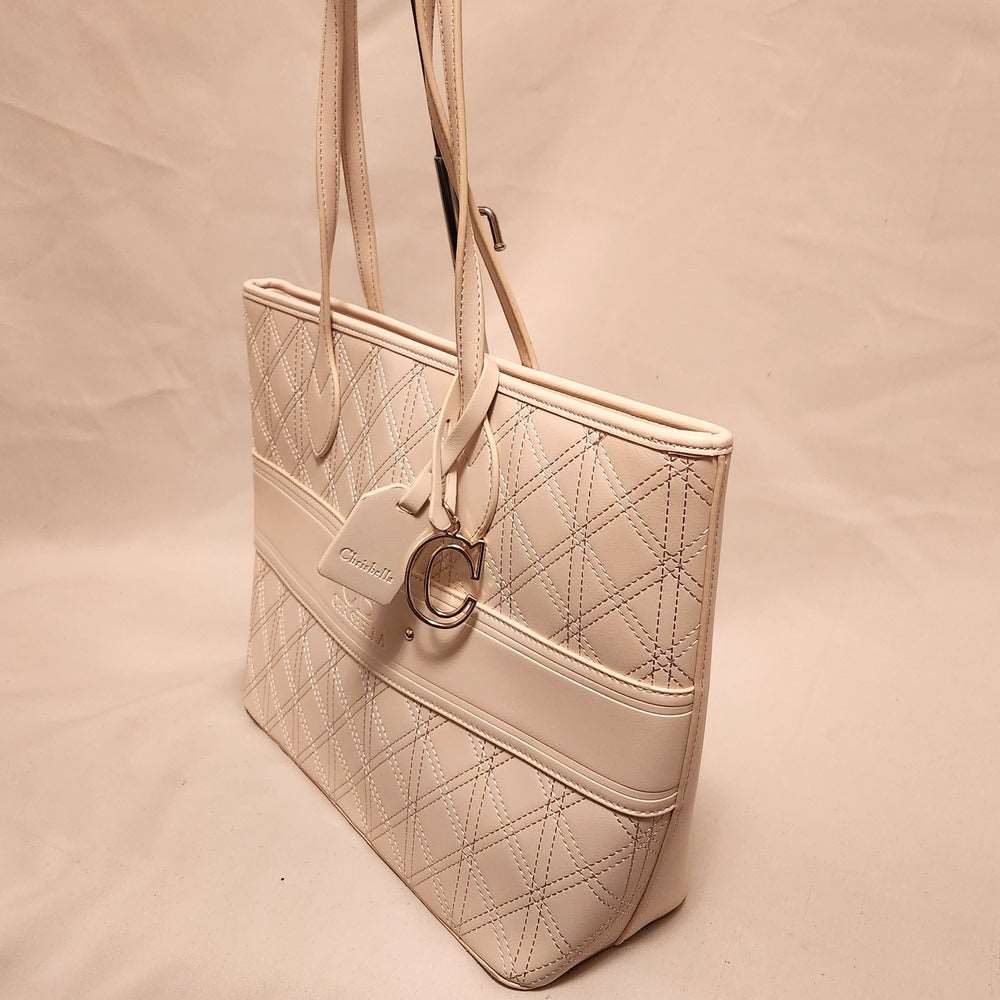 Side view of cream handbag  with gold hardware
