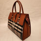 Side view of plaid pattern handbag with tan top handle