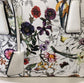 Detailed view of colorful floral print of white handbag