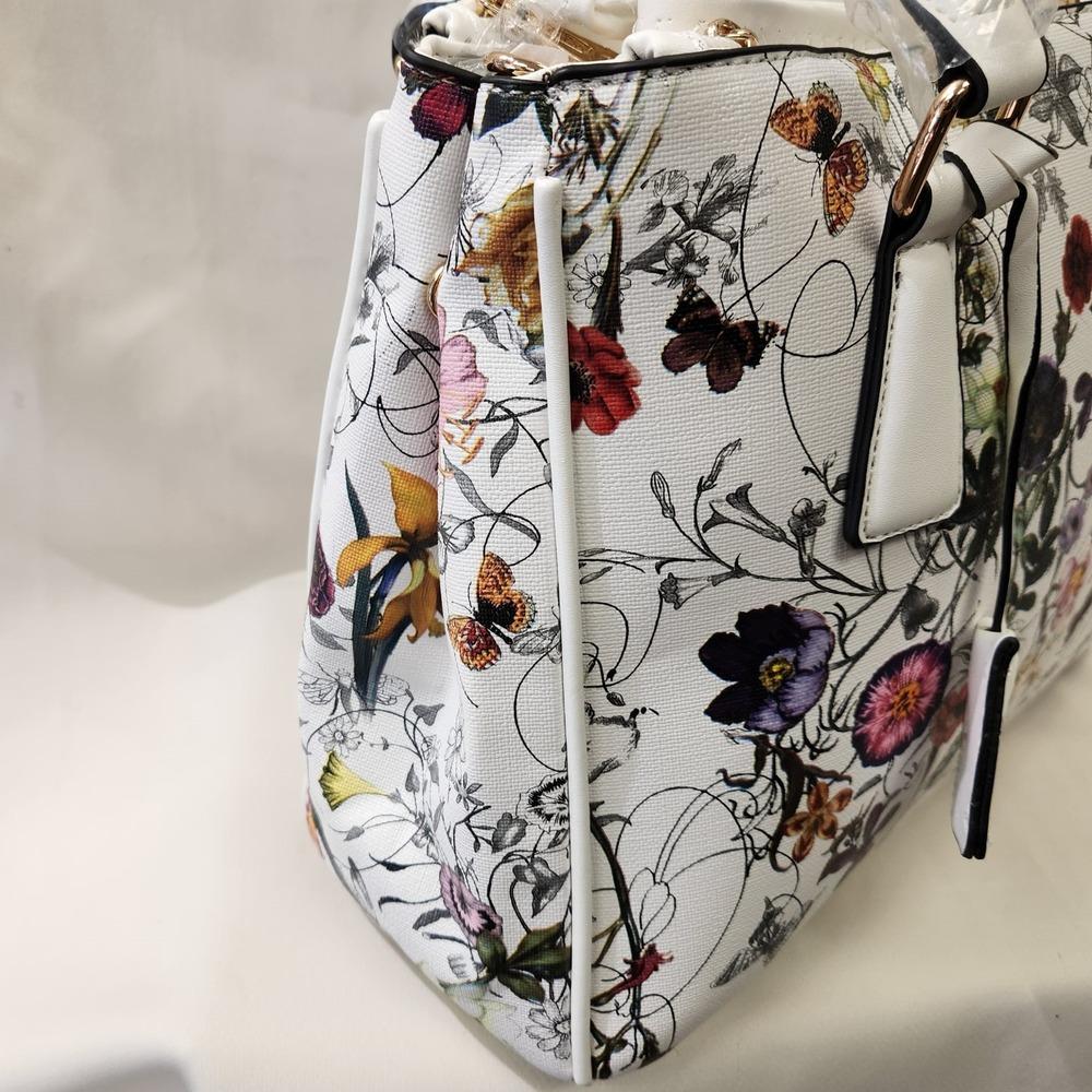 Side view of elegant white with colorful floral print handbag