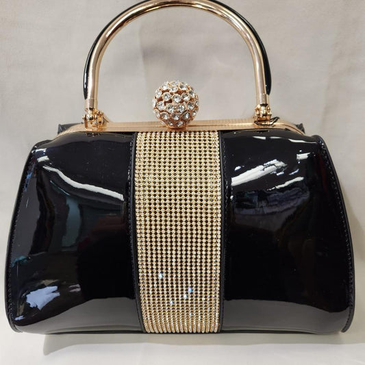 Front view of black patent handbag with stone embellished front