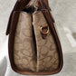 Side view of Printed handbag with brown top handle