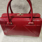 Detailed view of Red patent Fold-top handbag