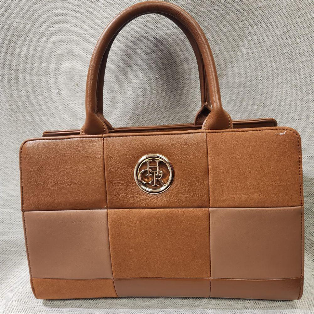 Detailed view of Structured tan handbag  