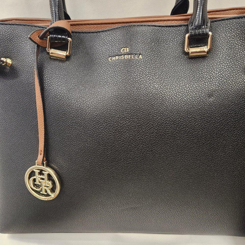 Detailed view of Black handbag with tan and grey accent colors