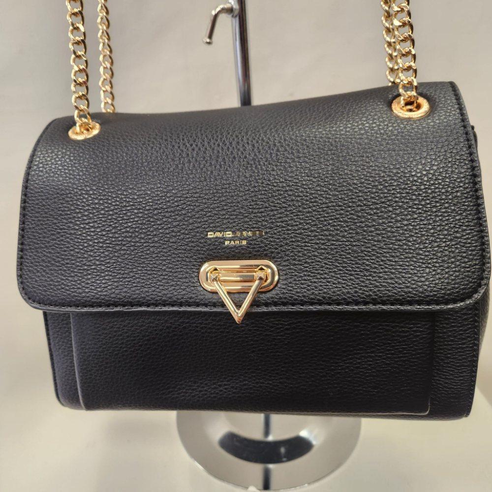 Detailed front view of Elegant black handbag with gold colored chain strap