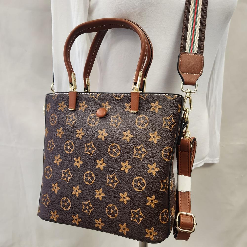 Detailed front view of Brown handbag with tan graphic print 