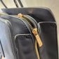 Gold hardware of navy blue handbag