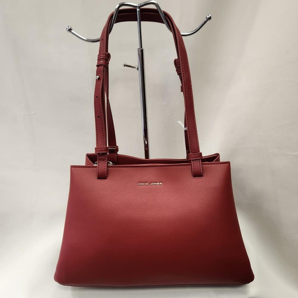 Mid size burgundy colored handbag