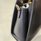 Side view of black handbag