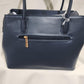 Rear view of Mid size blue colored handbag