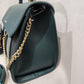 Side view of teal handbag 