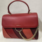 Gold chain detailing of red color graded handbag