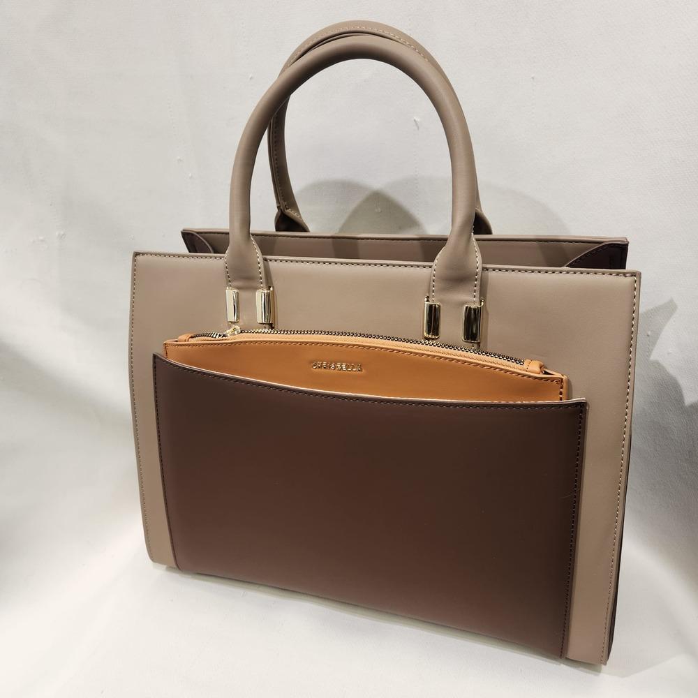 Mud color handbag with camel colored slip in pouch