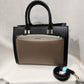 Black handbag with top handles and shoulder strap