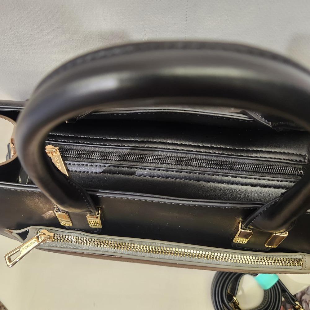 Top view of main zipped compartment of black handbag