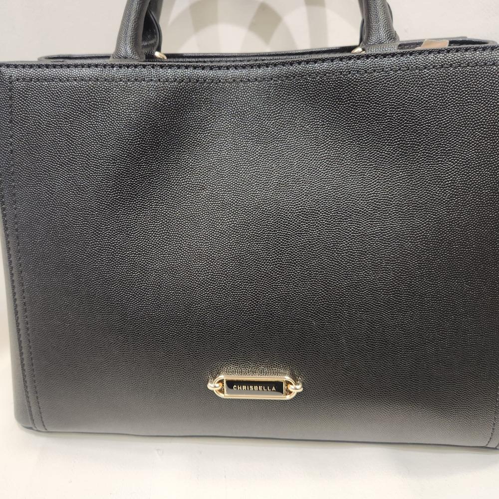 Detailed front view of classic black mid size handbag