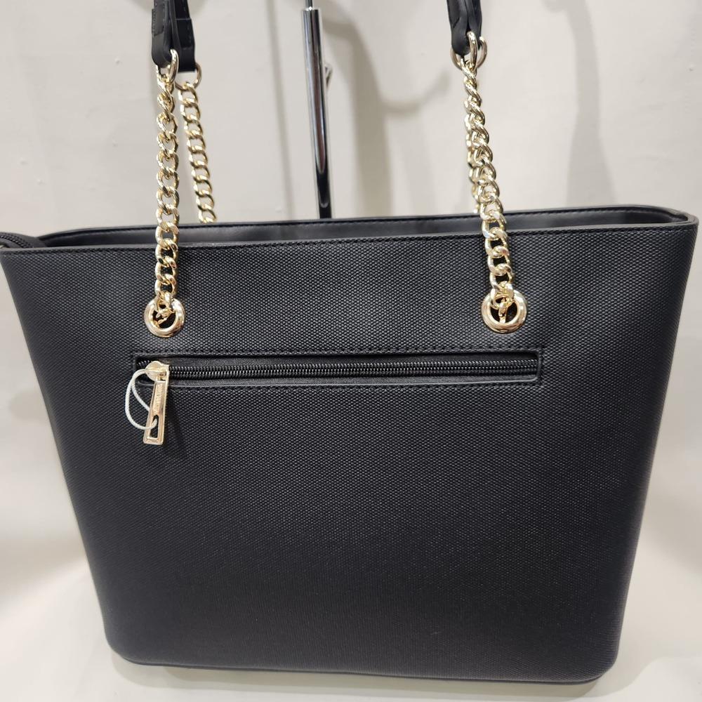 Rear zipped pocket of black handbag