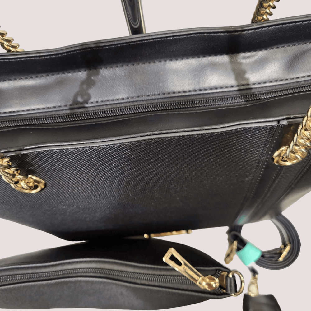 View of the zipped compartment of black handbag