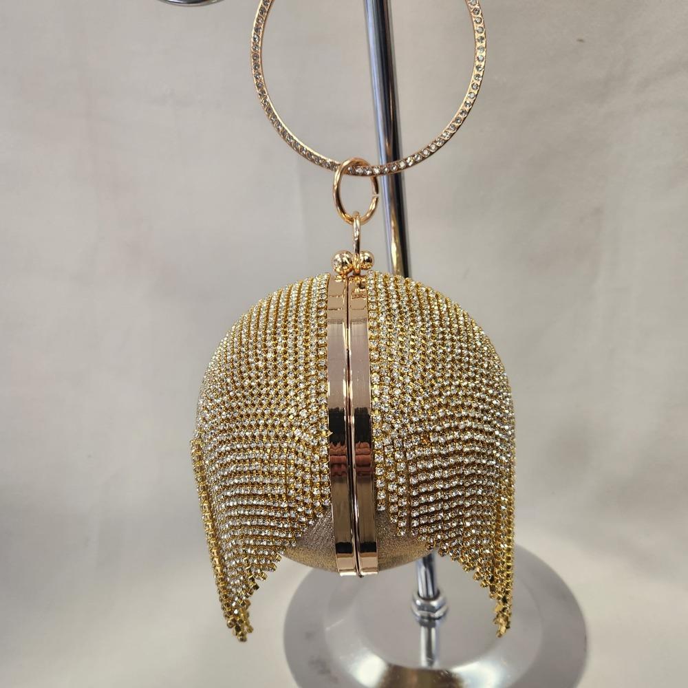 Side view of gold globe shaped party purse