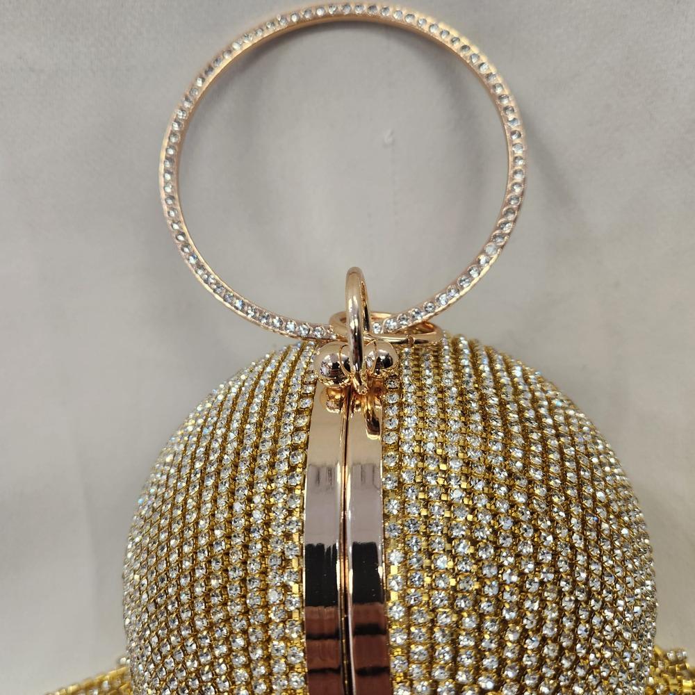 Detailed view of round gold handle with stone embellishment
