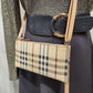 Detailed view of Beige side bag with plaid pattern and adjustable shoulder strap