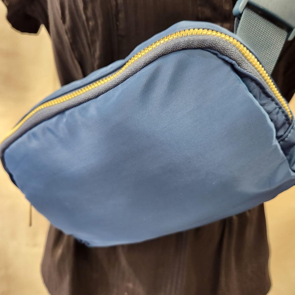 Detailed front view of blue microfiber side bag