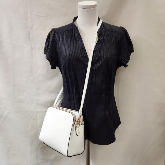 Full view of White side bag with triple main compartments