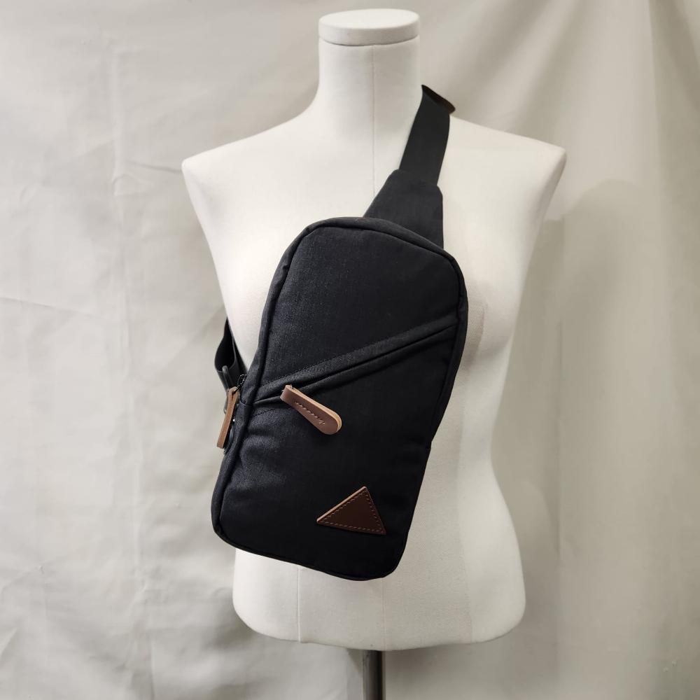 Another front view of Multi pocket black side bag with tan details 