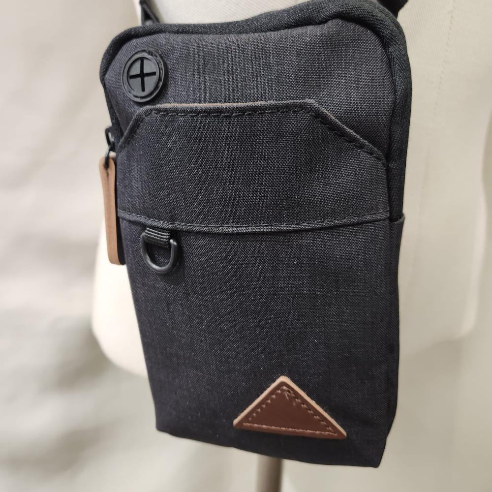 Detailed front view of Black side bag with a belt loop