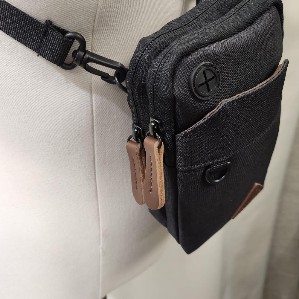 Side view of Black side bag with a belt loop