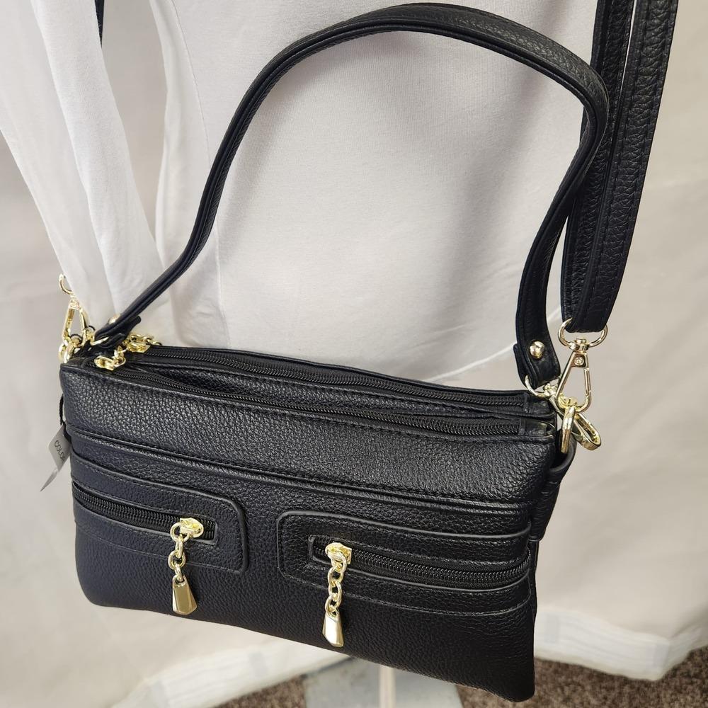 Another view of black side bag with multiple pockets 