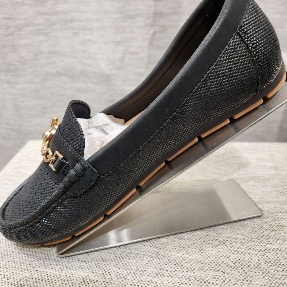Side view of Black color flat shoes for women with gold buckle