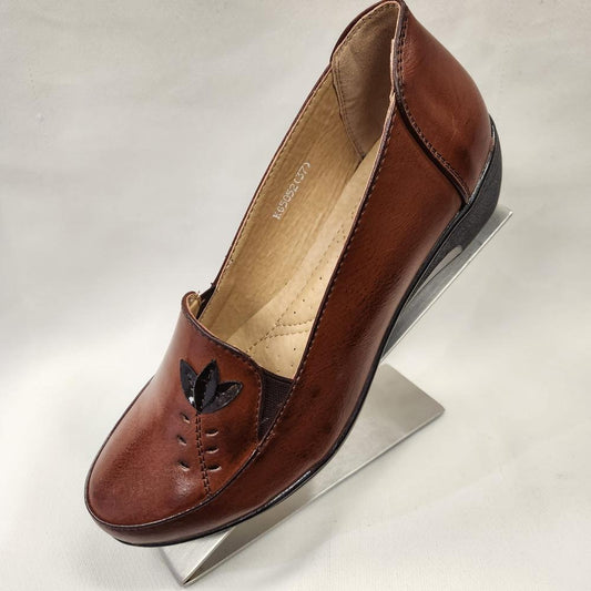 Side view of tan colored flat shoes