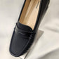 Detail of textured front of black flat shoes
