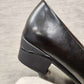 Detailed view of broad heels of black pumps