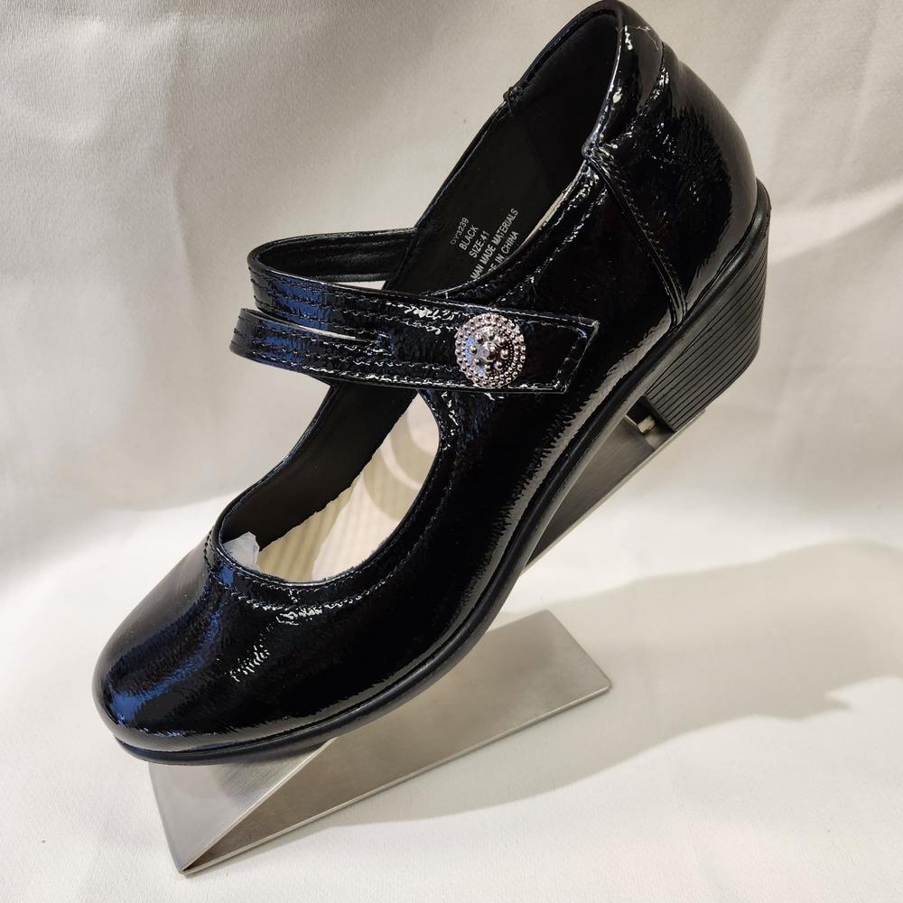 Side view of black broad heel patent pumps